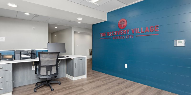 Rehab reception with desk and blue feature wall