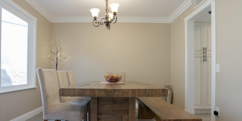 Dining room with rustic table, bench seating, and soft lighting