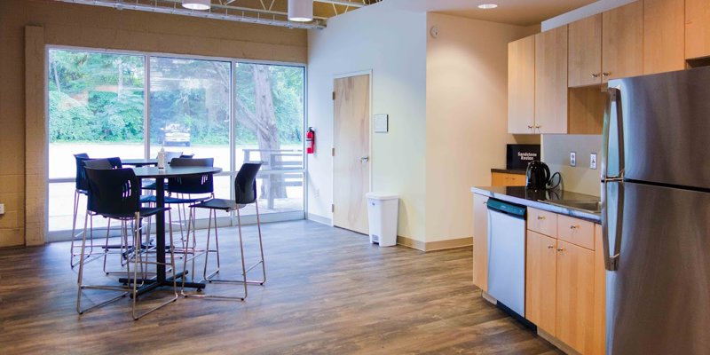 Cafeteria-style space offering tables, chairs, and shared dining.