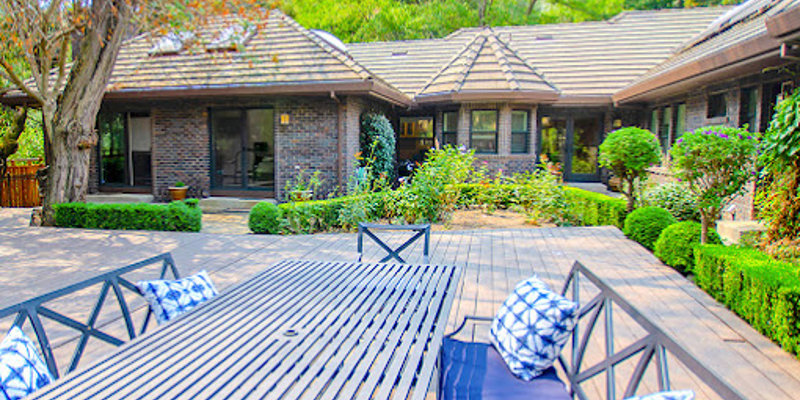 Outdoor deck with a table and seating.