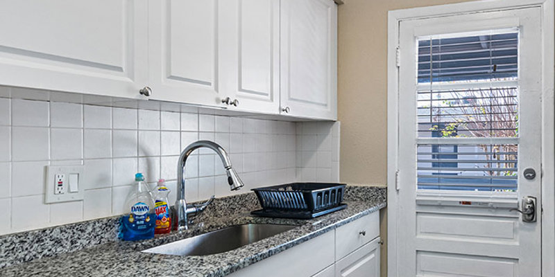 Kitchen with countertops next to entrance.