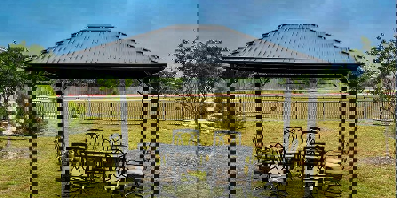 Outdoor seating area under a metal pergola.