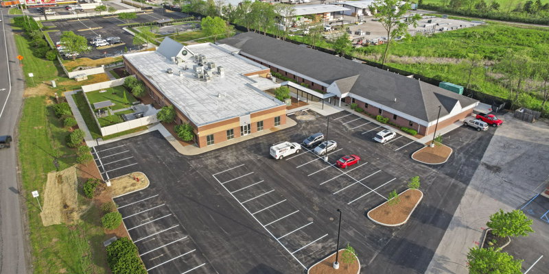 Aerial view of a large rehab facility with a parking lot.