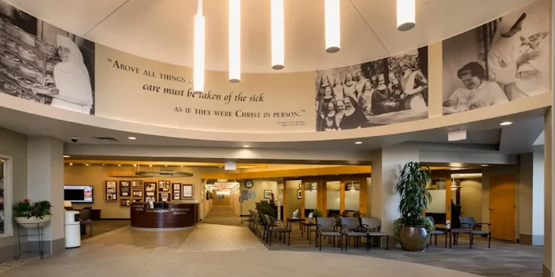 Curved lobby with chairs and wall art