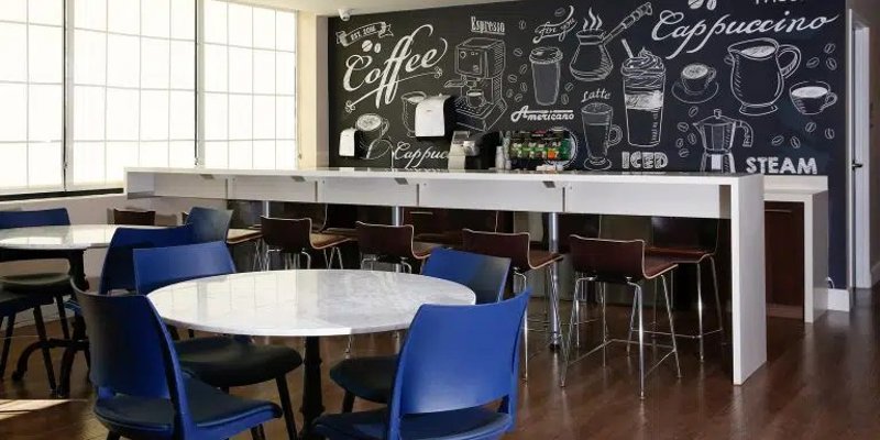 Coffee bar with chalkboard menu and casual seating.