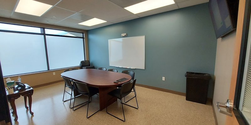 Group therapy room with chairs in a circle around a table.