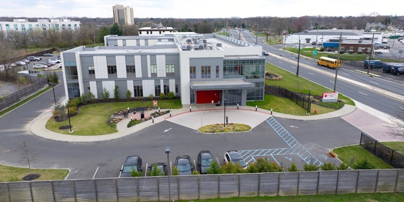 Aerial veiw of facility featuring modern design and signage.