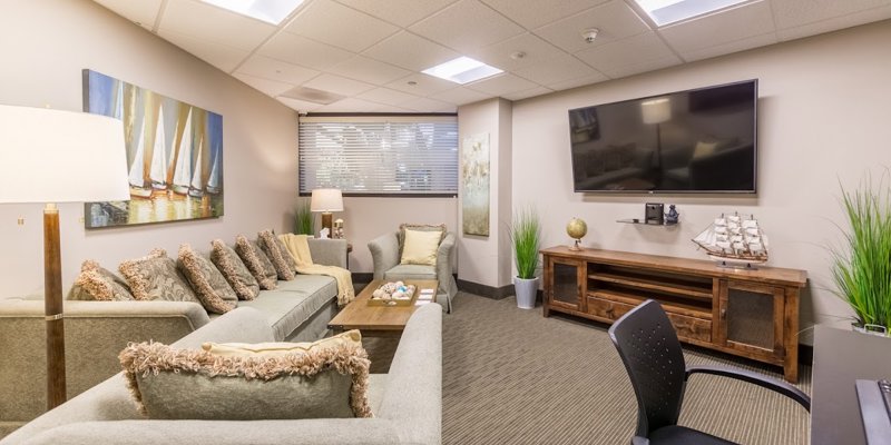 A cozy lounge with sofas, a TV, and nautical-themed décor