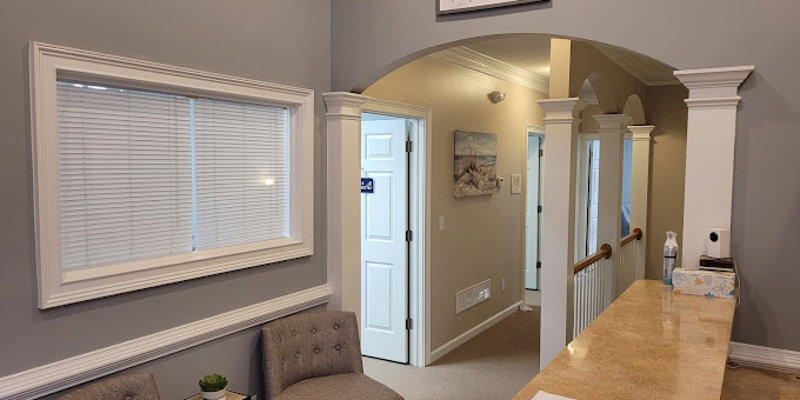A reception area with an arched entryway and a seating nook.