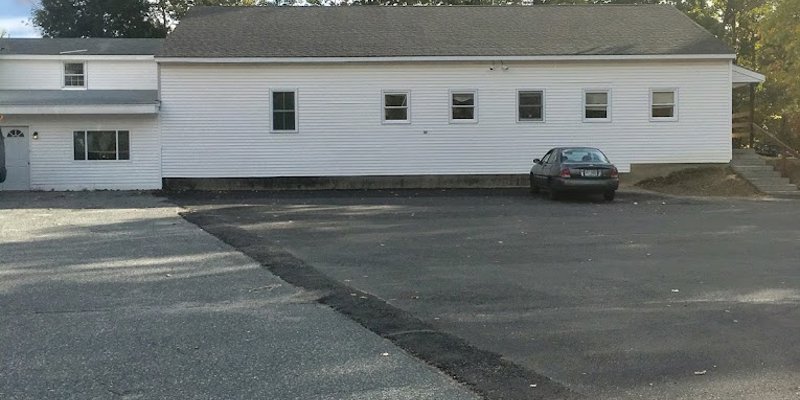 Facility exterior with parking and stairway to entrance.