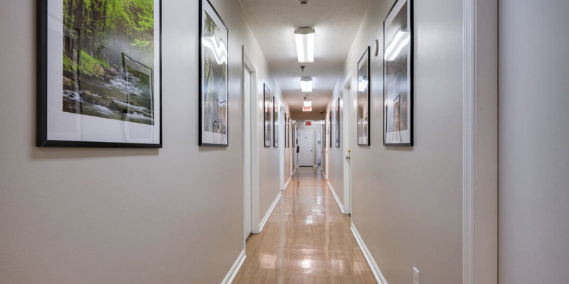 Hallway with framed nature photography and polished flooring.