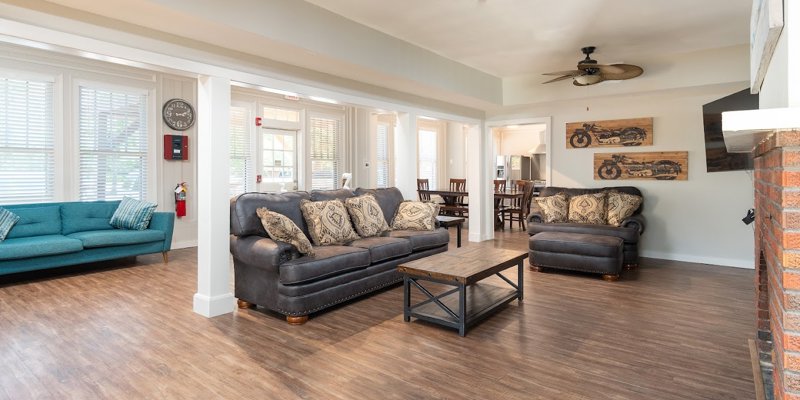 Lving space with sofas, a fireplace, and a TV.