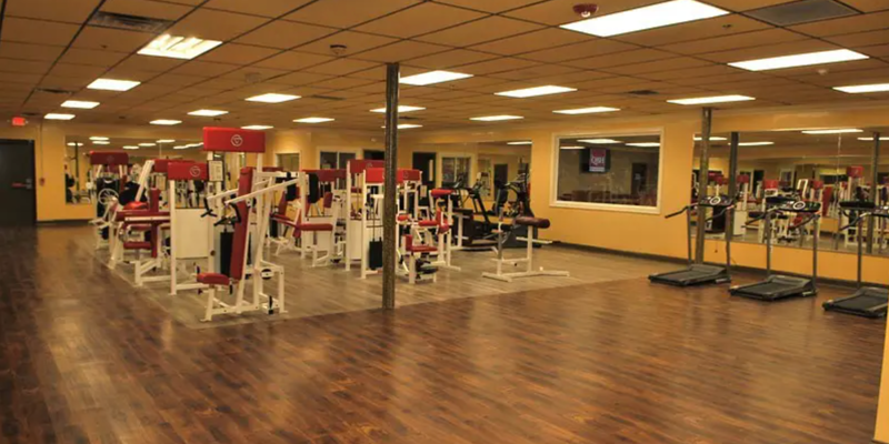 A well-equipped gym with various exercise machines and ample floor space.