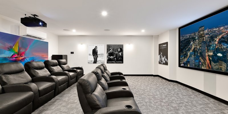 A private theater room with leather recliners.