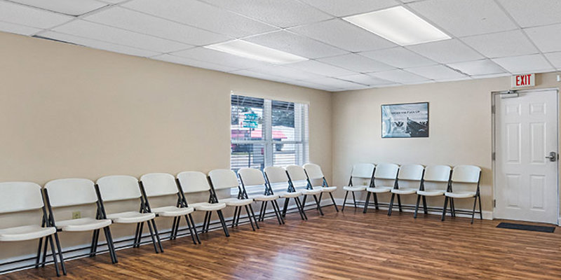 Group therapy room with chairs along the wall.