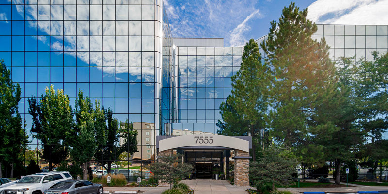 Facility exterior with glass facade and entry walkway.