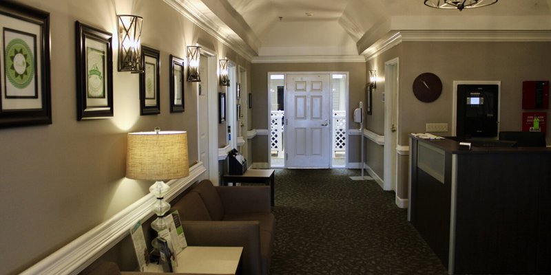 Reception desk and chairs in warmly lit hallway