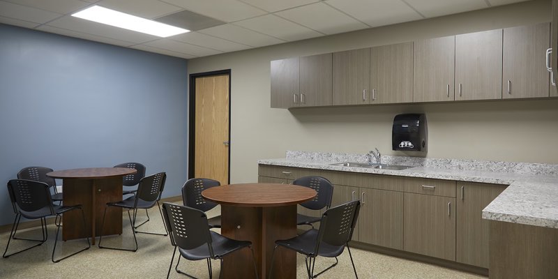 A kitchenette with tables and chairs.