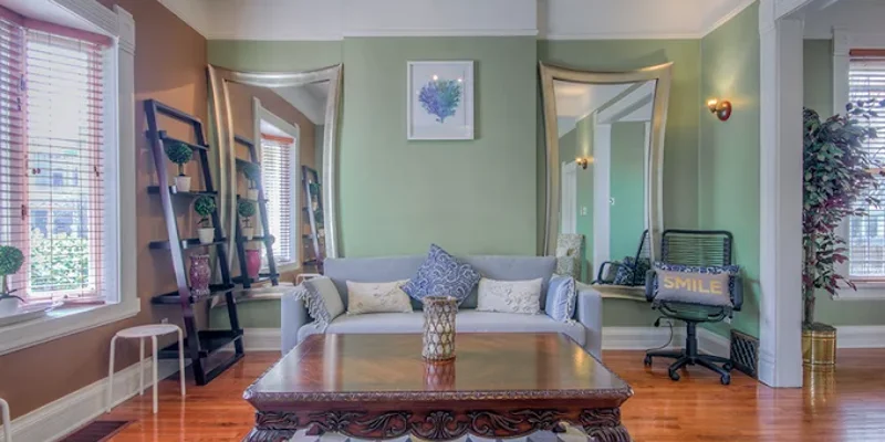 Sitting room with green walls and modern decor