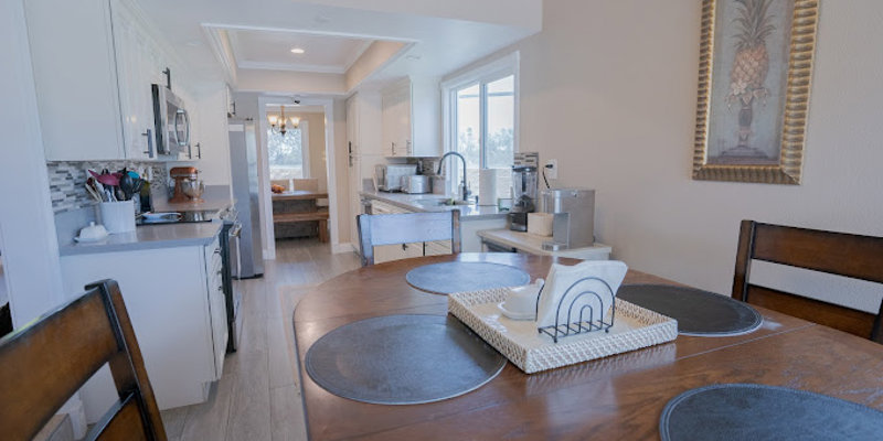 View of open kitchen leading into dining and living areas