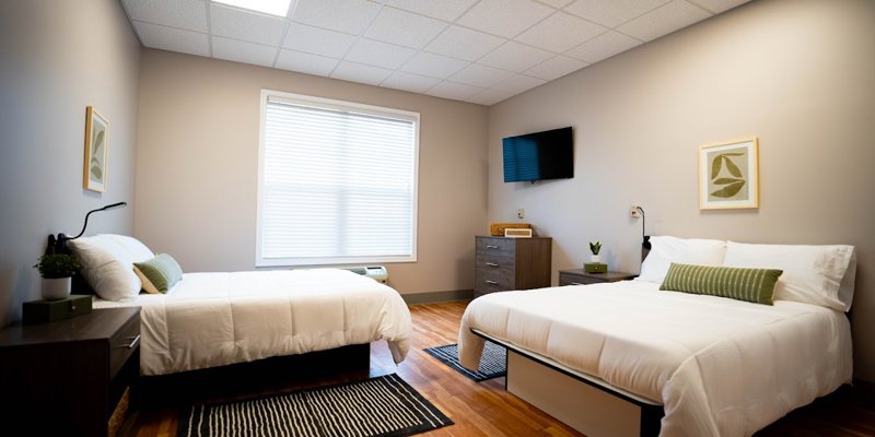 Double bedroom with white bedding and modern decor.