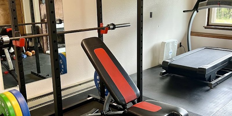 A rehab gym with weightlifting equipment and a treadmill.