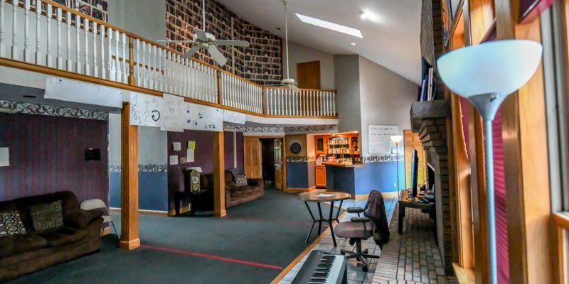 Spacious rehab facility lounge with a loft, seating, and decor.