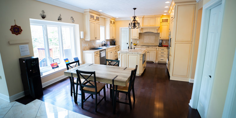 Large kitchen with wood cabinets and small dining table