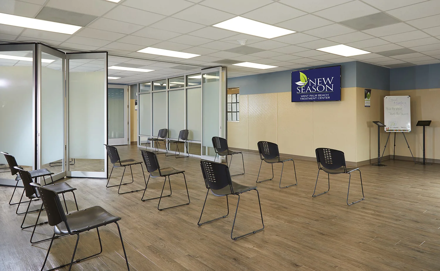 Group therapy room with chairs and a TV.