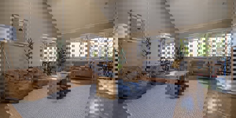 A spacious living area with bean bags and modern decor.