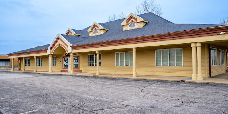 Exterior of Indiana Center for Recovery with a yellow facade and columns.