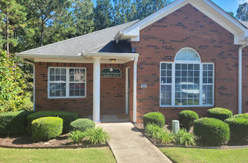 The exterior of Inner Voyage Recovery Center, a brick building with greenery.