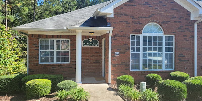 The exterior of Inner Voyage Recovery Center, a brick building with greenery.