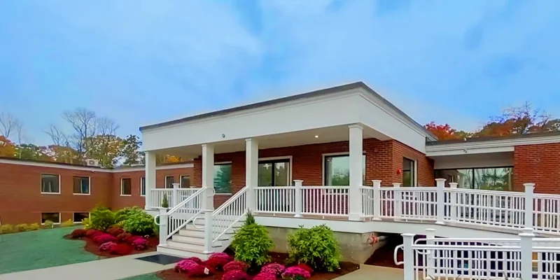 Red-brick facility with white columns and landscaped front entrance