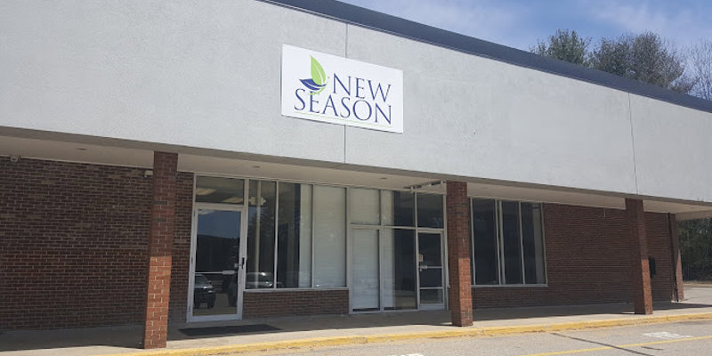 Facility exterior with extrance, accessible parking and signage.