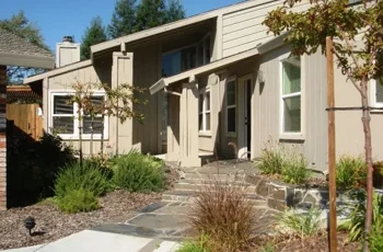 Stone walkway leading to entrance of residential rehab home