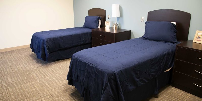 Two twin beds with nightstands in a shared room