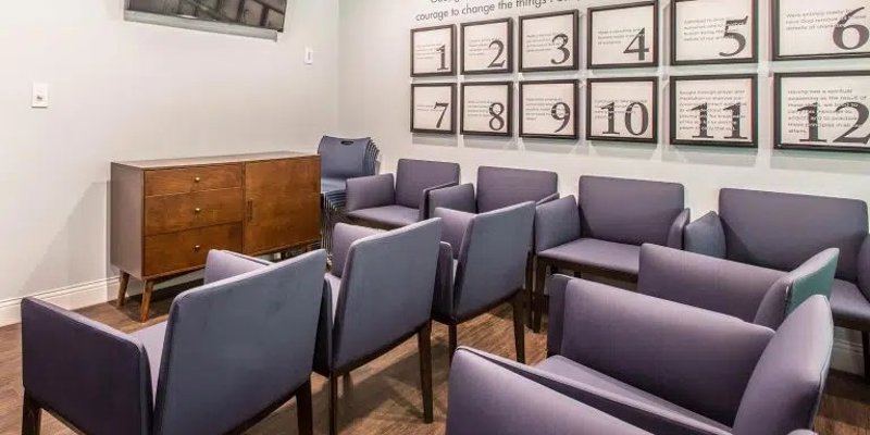 Group therapy room with arranged chairs.