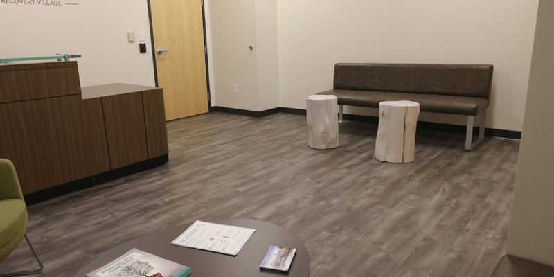 Reception area with a desk and seating in a rehab facility.