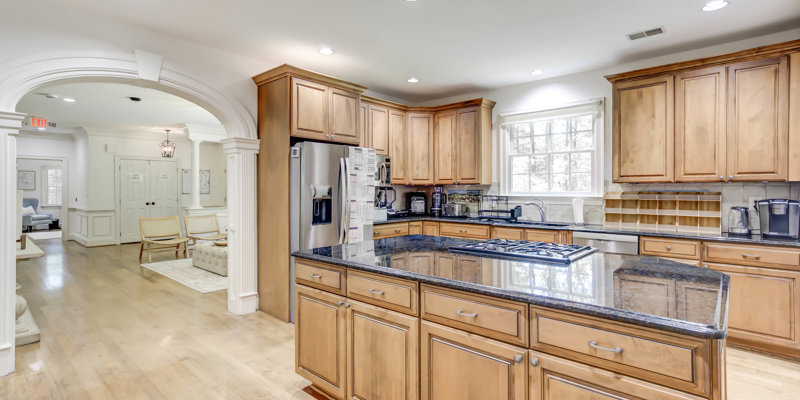 Kitchen with wood cabinets and granite island.