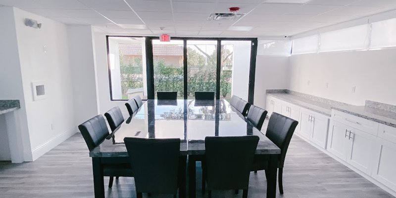Conference room with a table, chairs. and windows.
