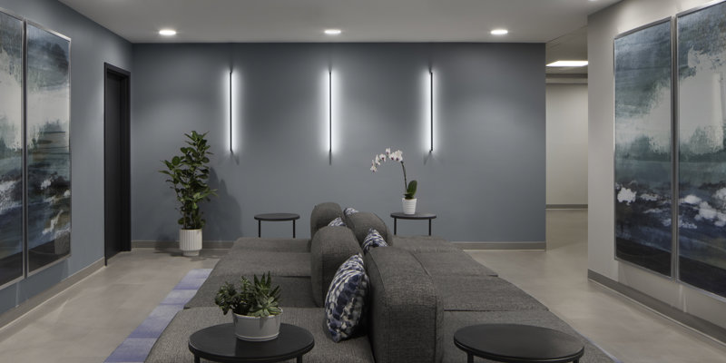Gray sectional sofa and wall art in a waiting area