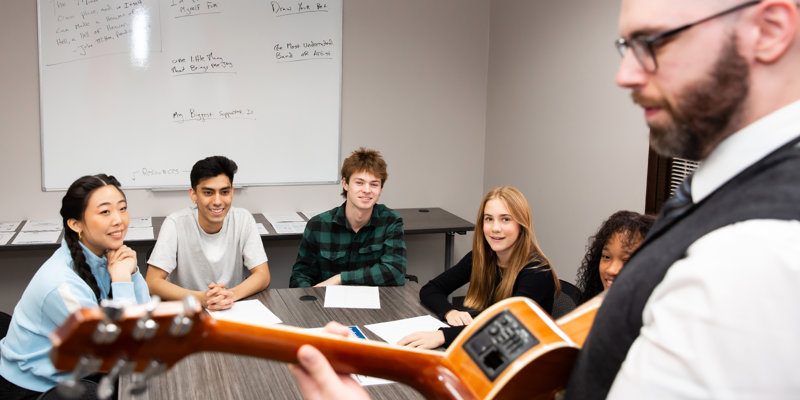A music therapy session with a guitar instructor